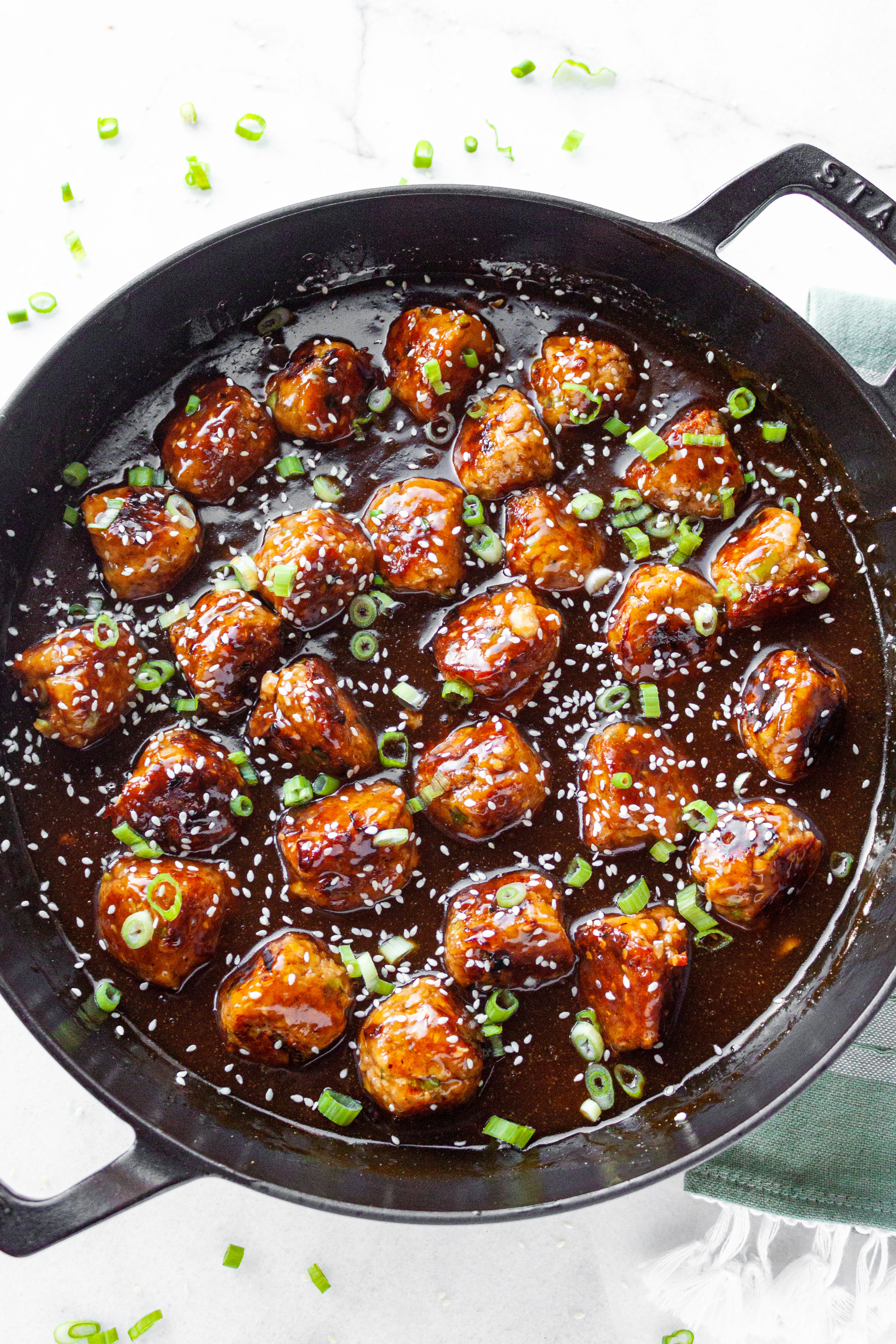 Finished Teriyaki Salmon Meatballs in a large black skillet