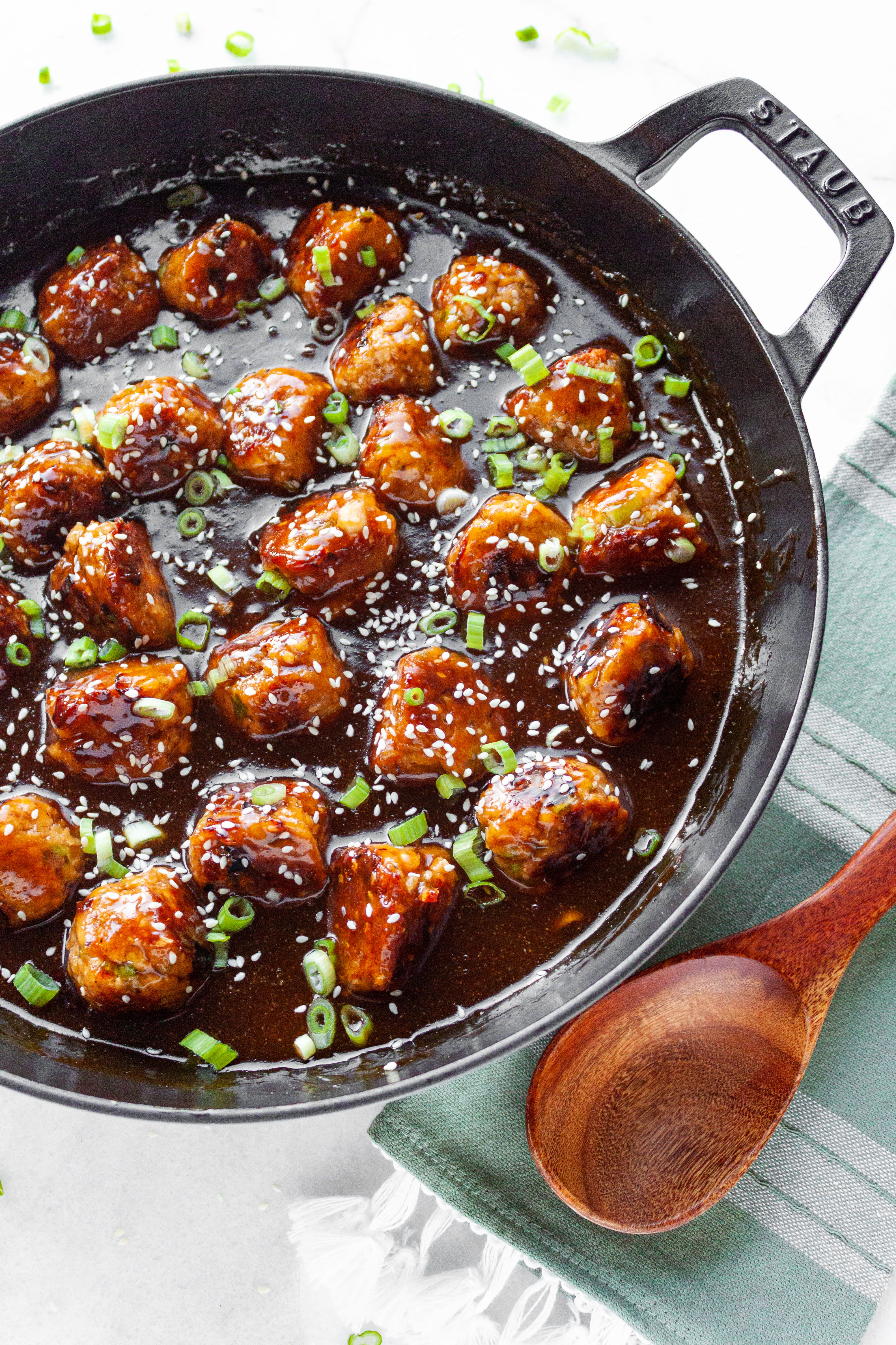 Finished meatballs garnished with sliced green onions and sesame seeds