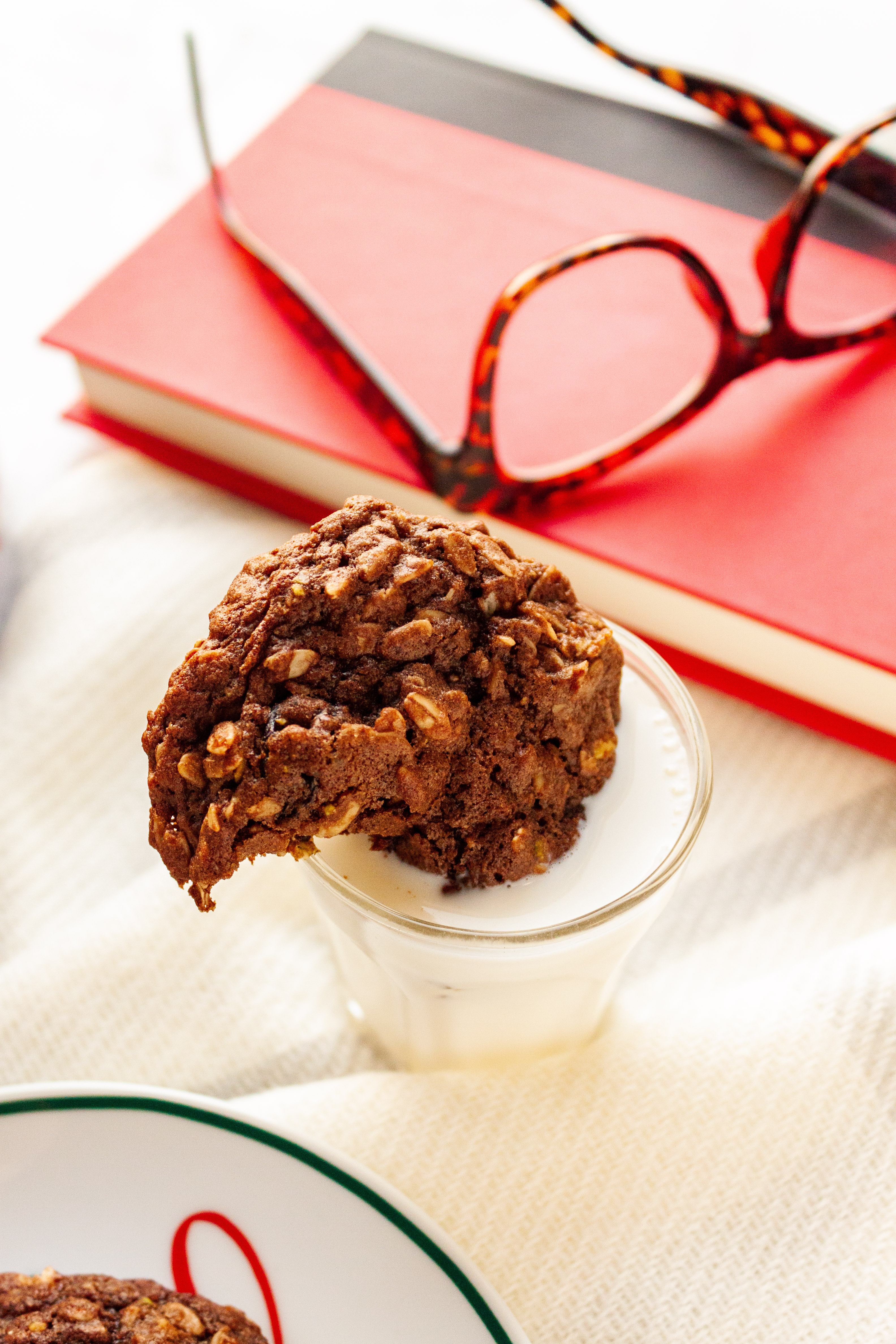 A cookie dunked in a glass of milk