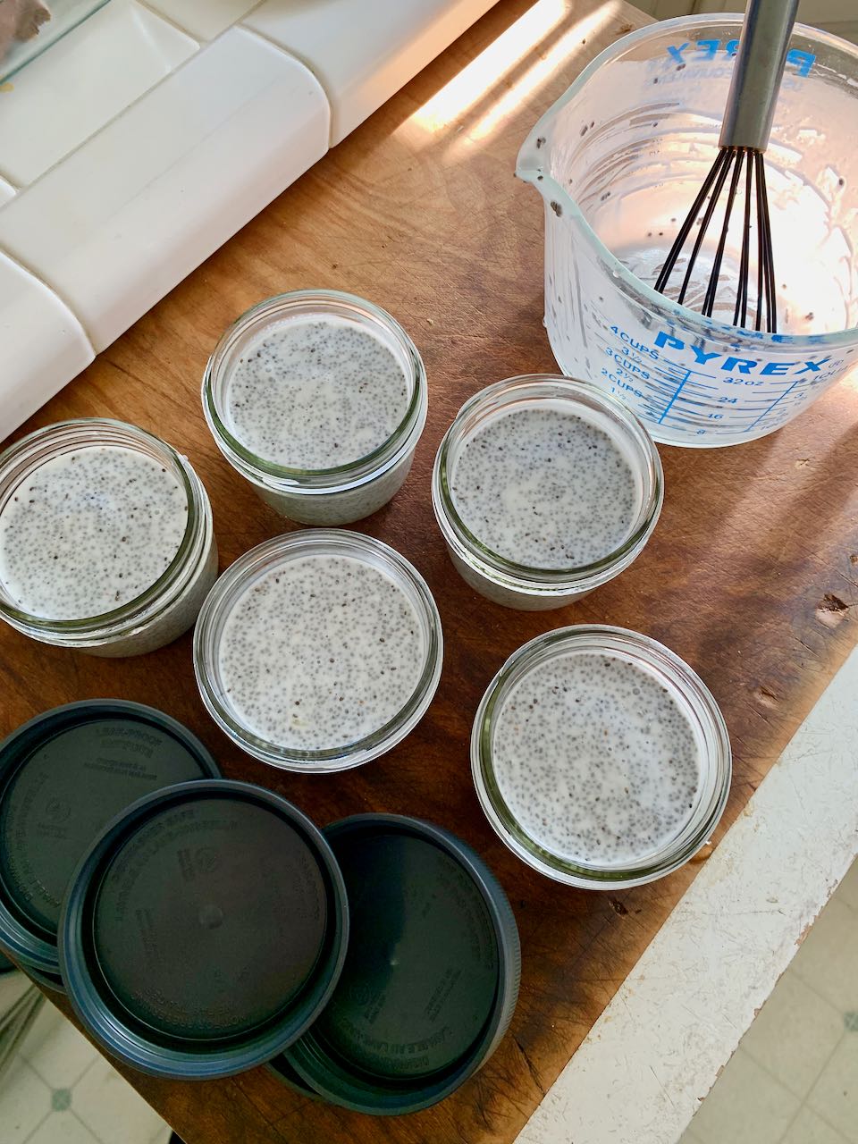 Chia pudding poured into five individual jars with lids