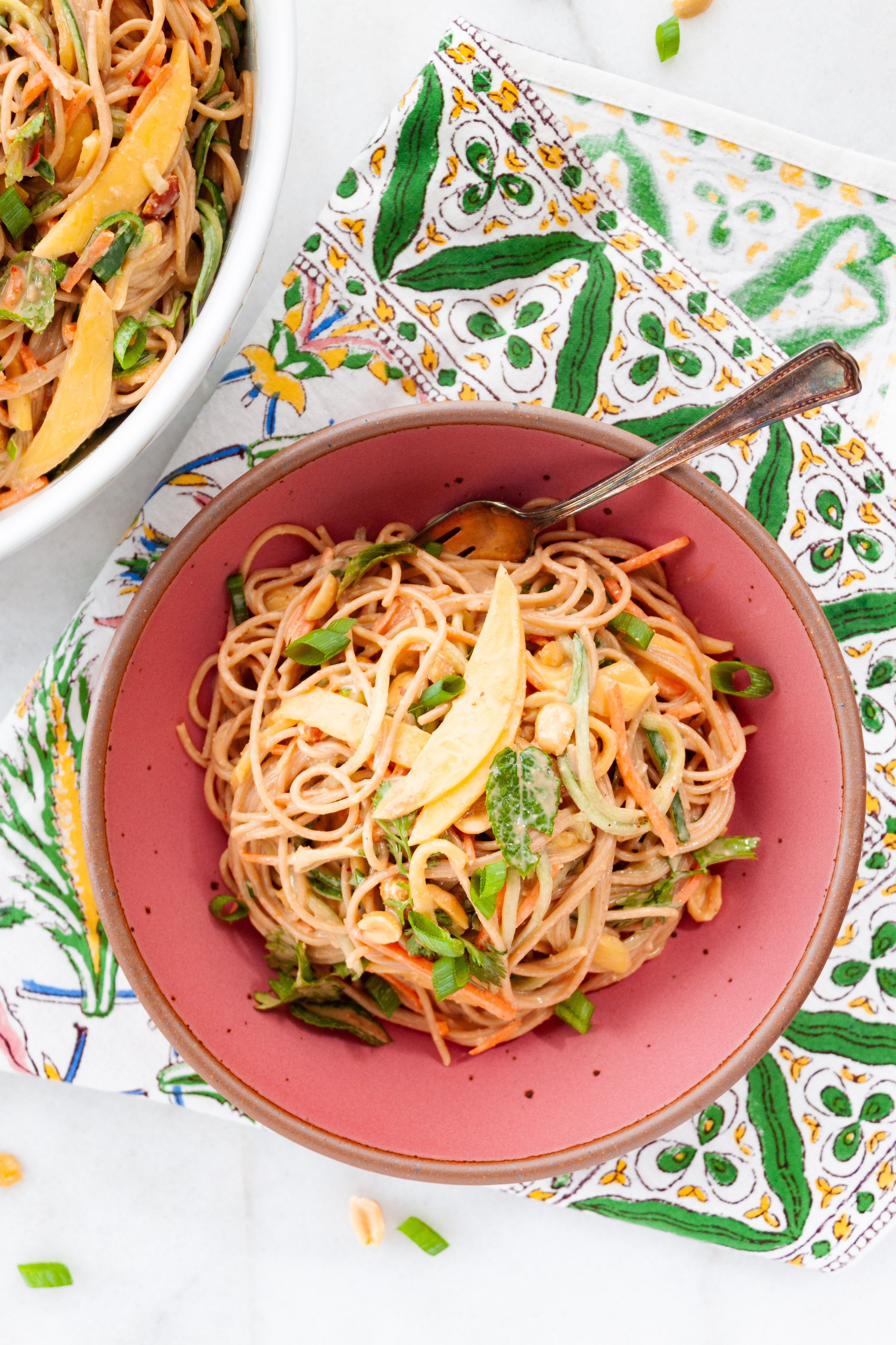 Mango Peanut Noodle Salad served in a pink stoneware bowl