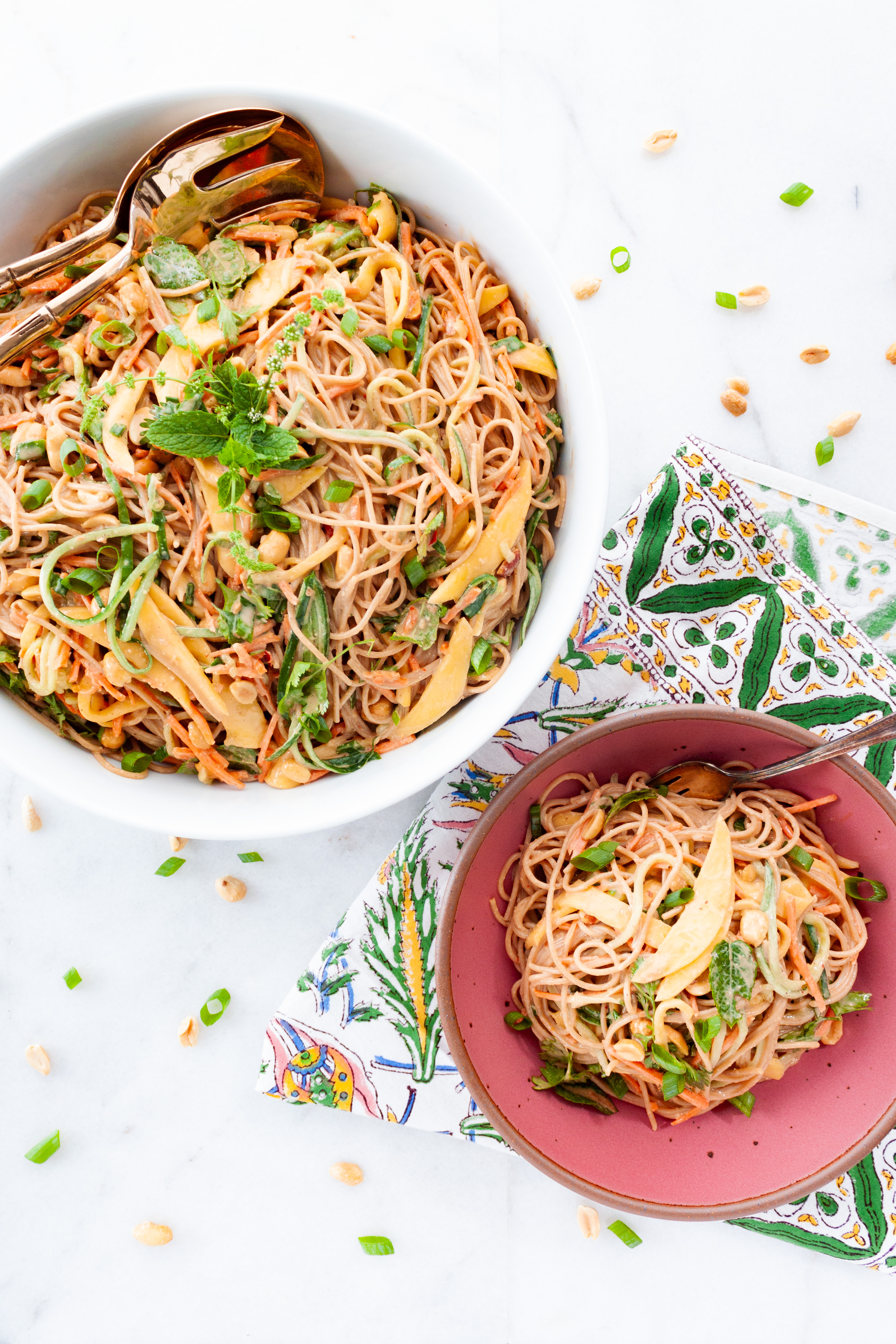 Mango Peanut Noodle Salad on a white backdrop