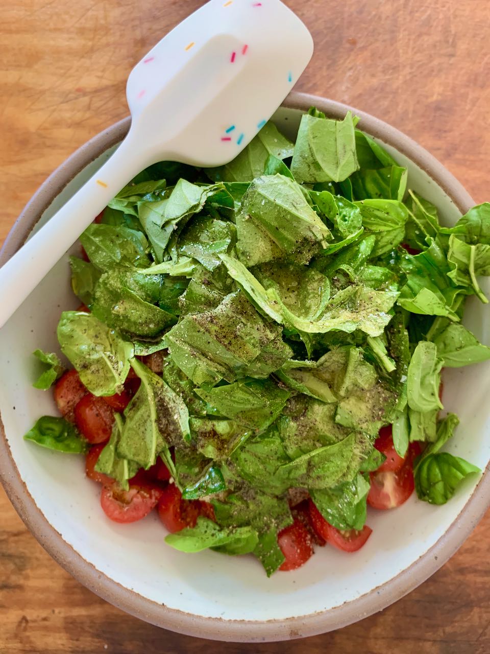 Chopped tomatoes and basil in a bowl 