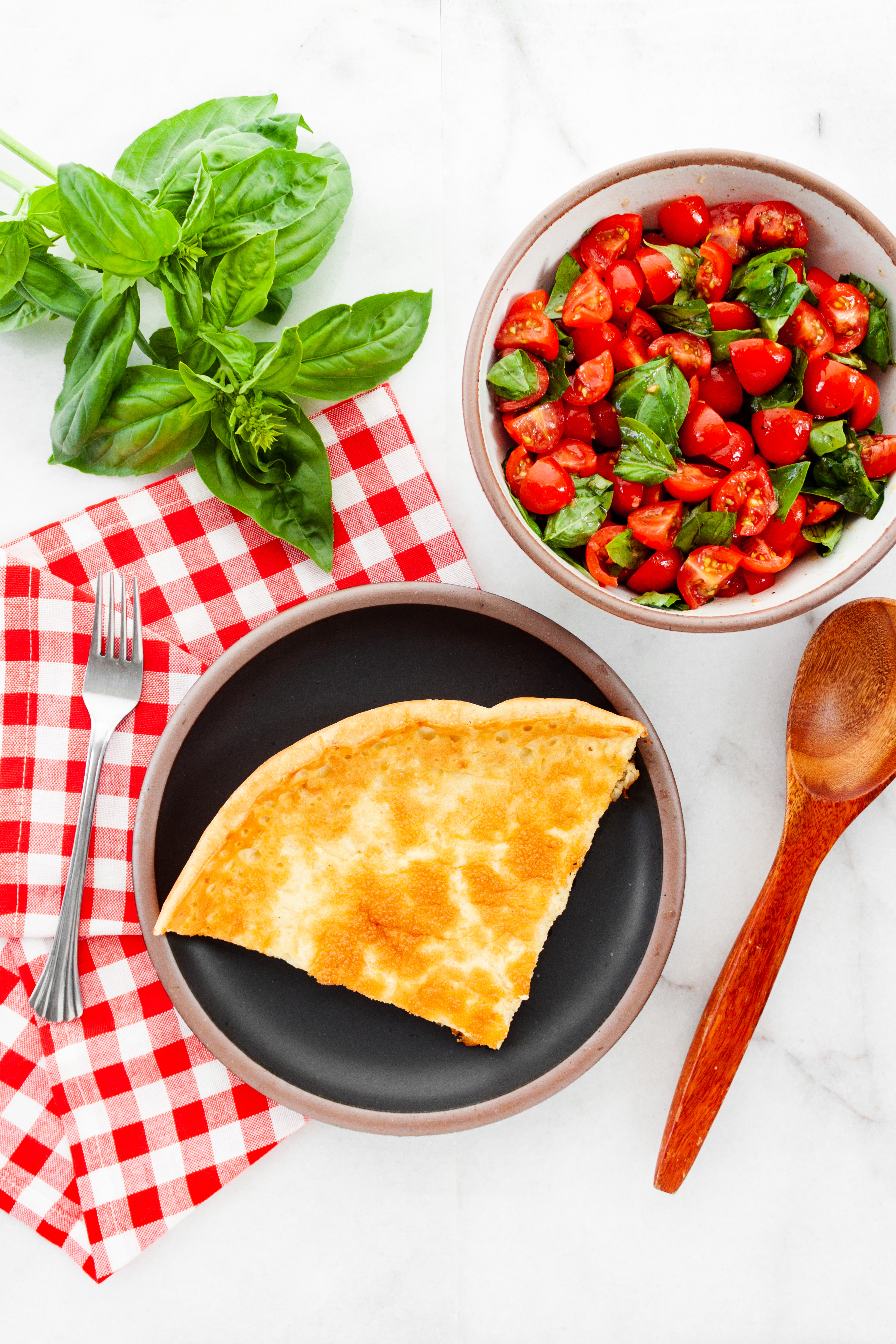 A slice of Dutch baby on a black plate