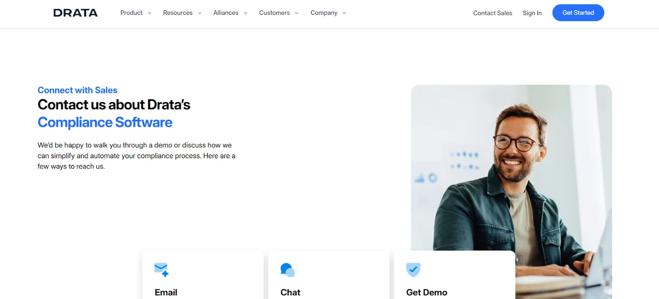 Drata contact sales page with a smiling man and Email, Chat and Get Demo options