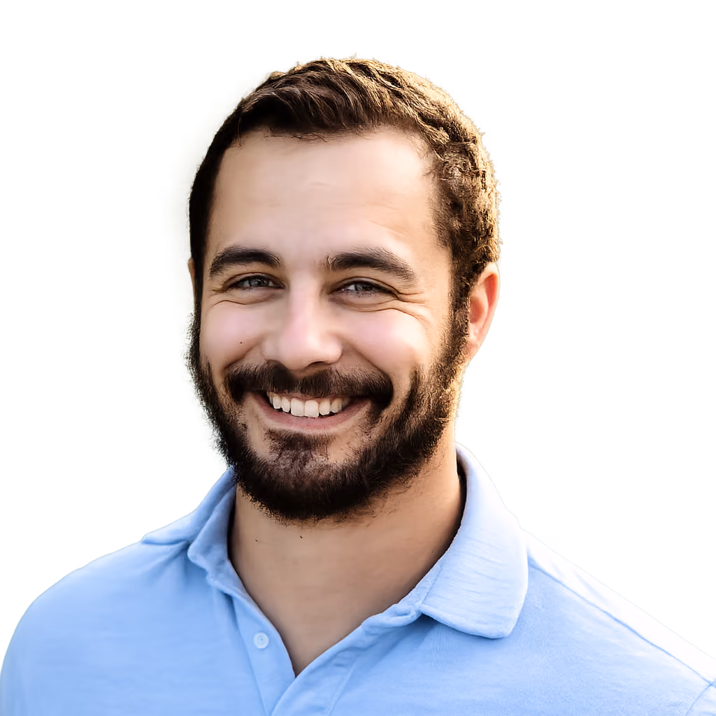 Headshot of a smiling man in a light blue polo shirt.