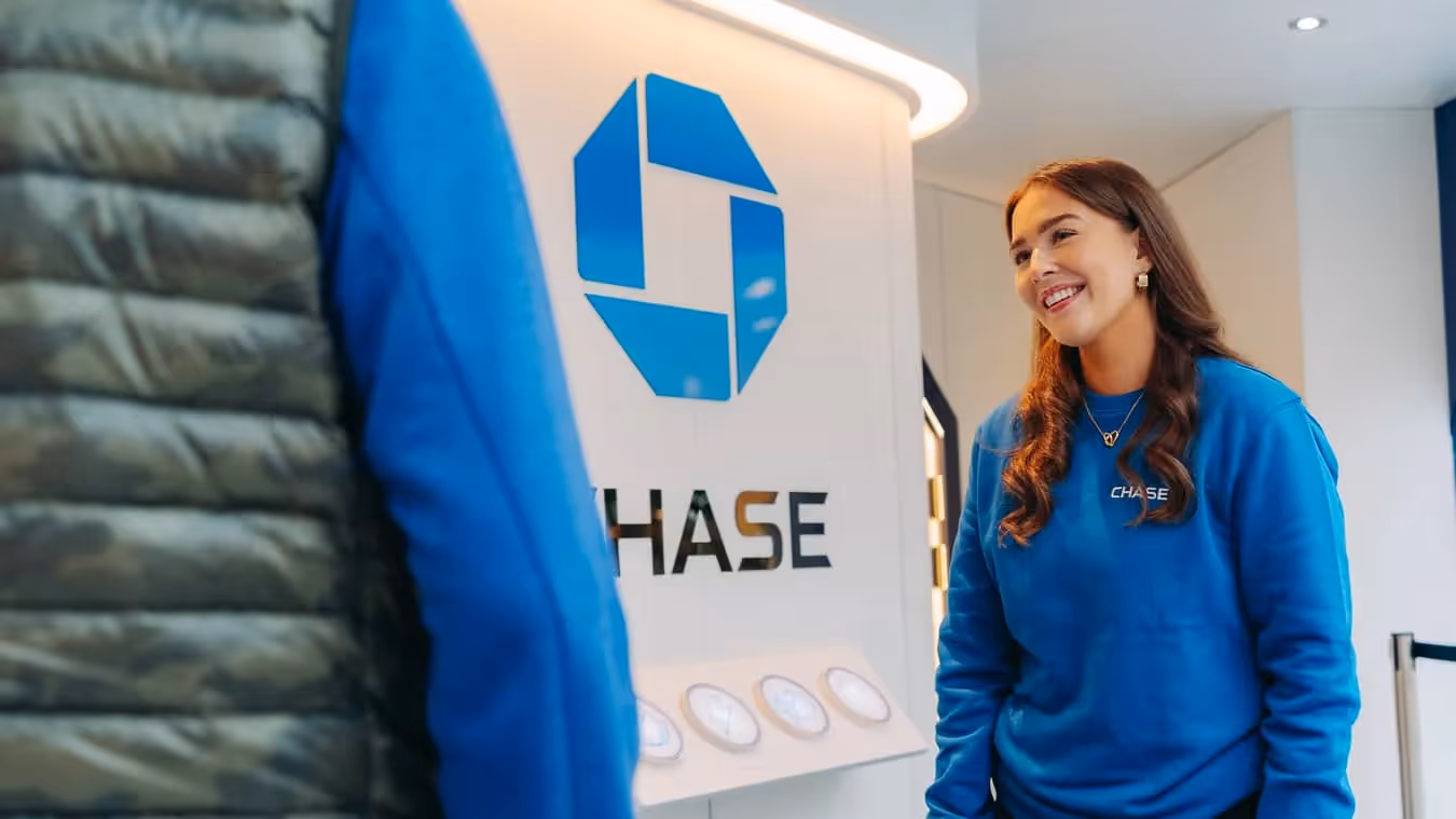 Experiential staff in the blue branded sweatshirts smile at the entrance if the Chase Octagon