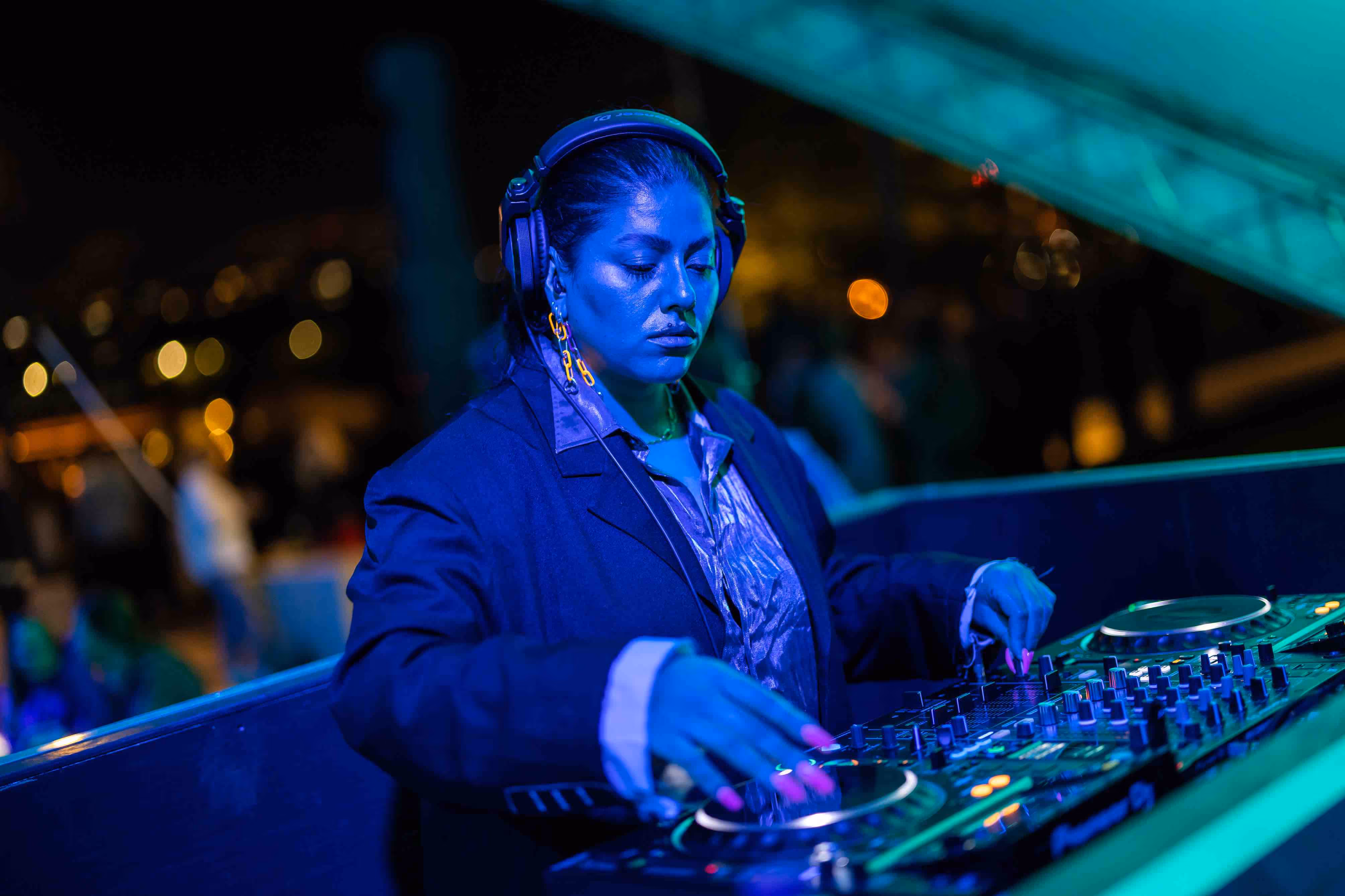 A female DJ, plays CDJs at the Battersea Power Station launch event.