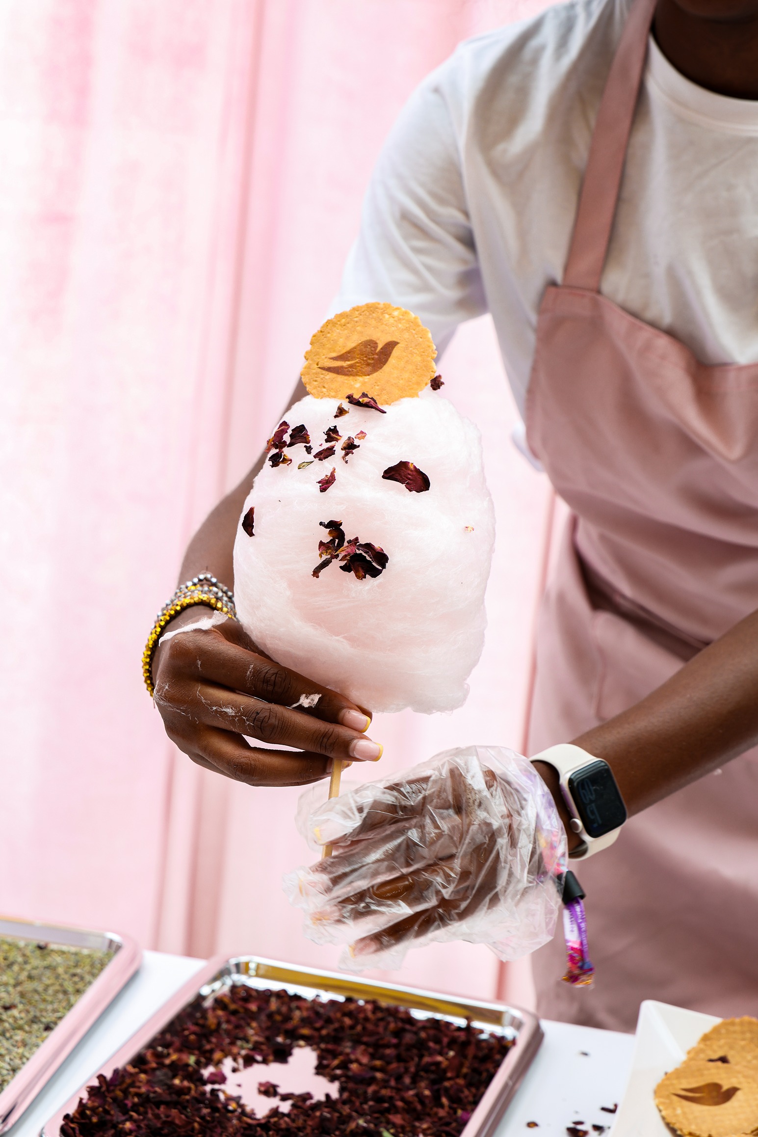 Woman serving candy floss with Dove branded wafer at 'Backstage with Dove' beauty pop-up by Bearded Kitten