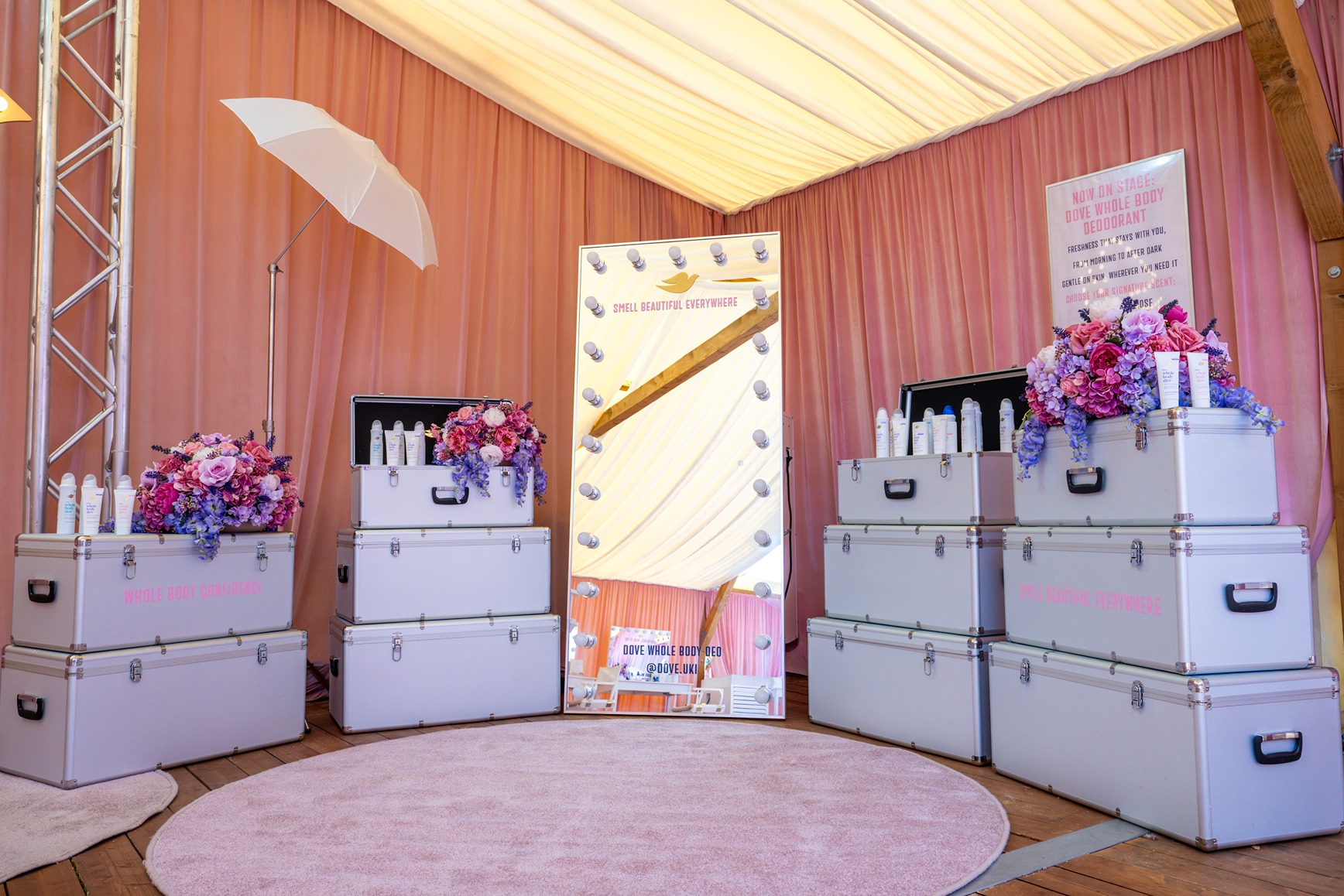 Silver trunks dressed with pink florals and showcasing Dove deodorant at 'Backstage with Dove' beauty pop-up by Bearded Kitten