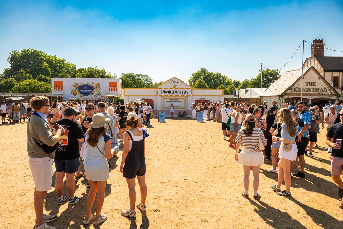 Two long lines of festival-goers queuing up for the 'Backstage with Dove' beauty activation by Bearded Kitten