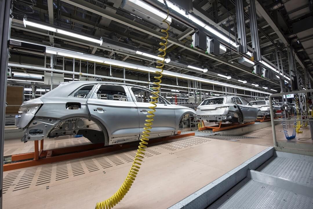 Bare vehicle shells on an assembly line