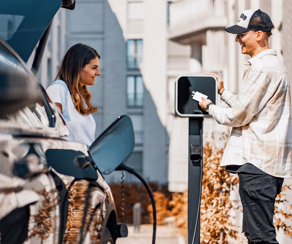 People chatting while paying for EV charging with a card