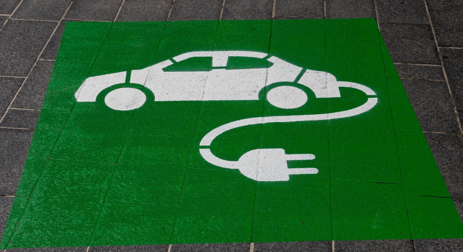 Electric vehicle charging sign on ground