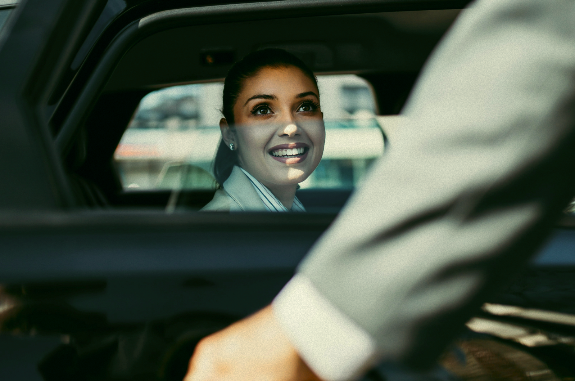 Smiling employee entering an electric car as part of an EV salary sacrifice benefit