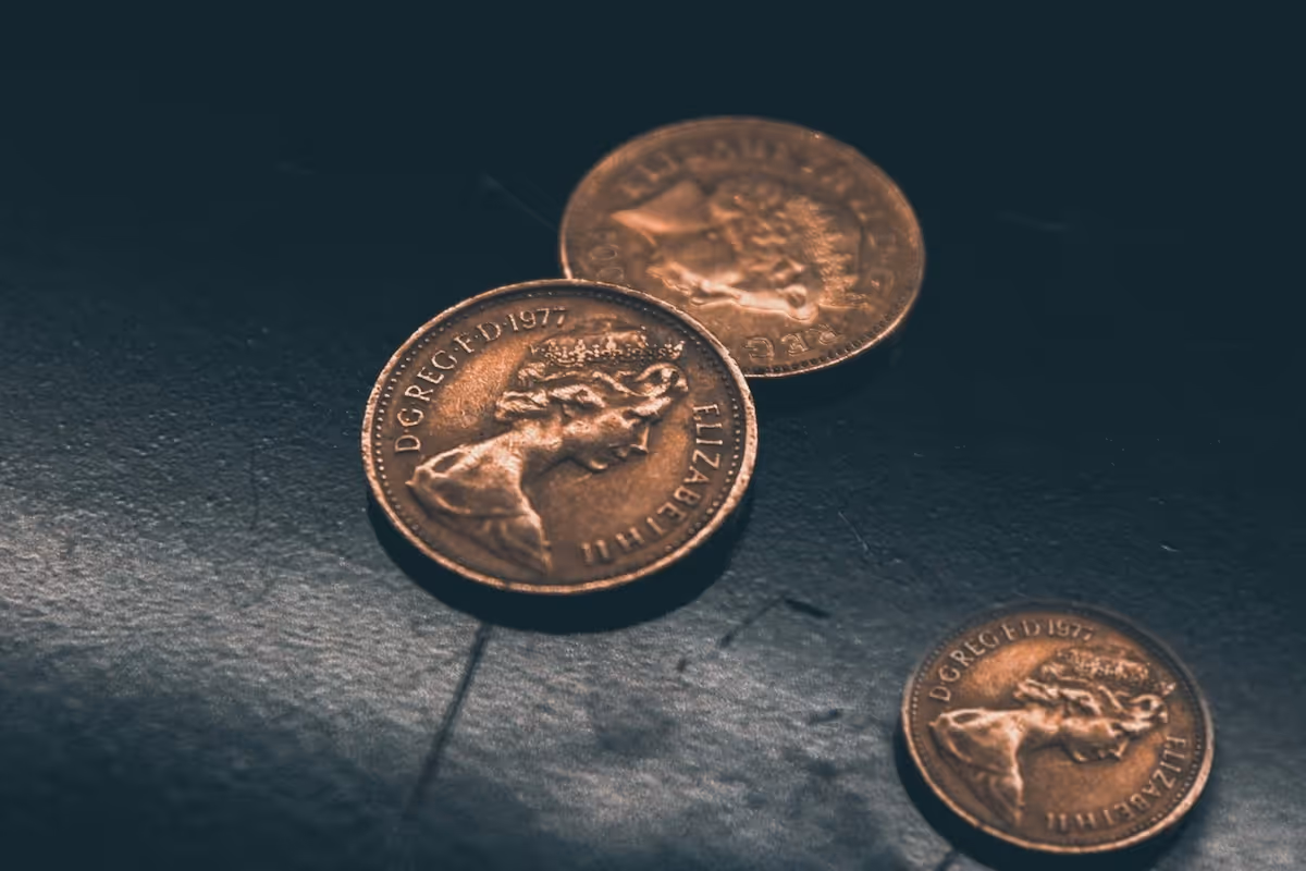 Three pennies on a dark background