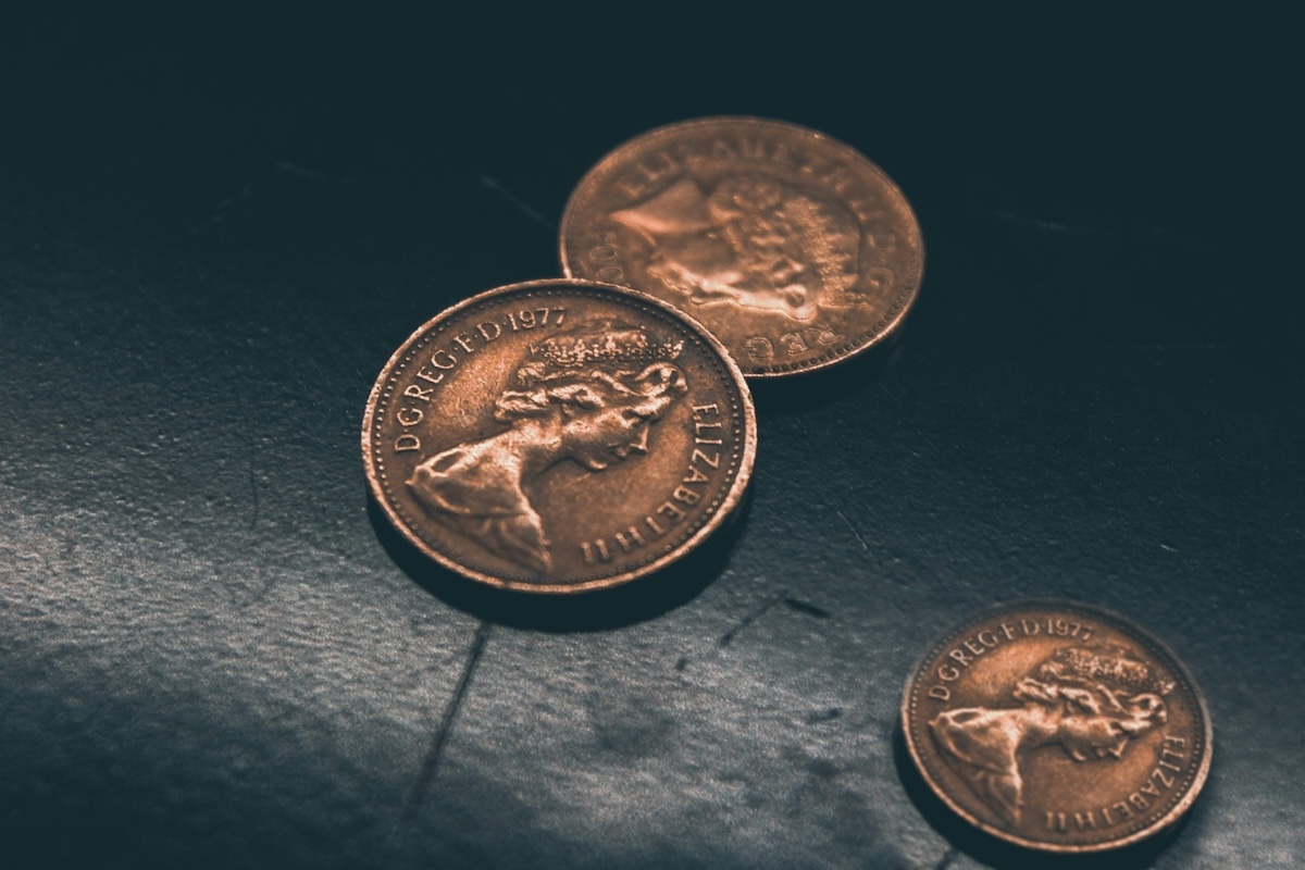 Three pennies on a dark background