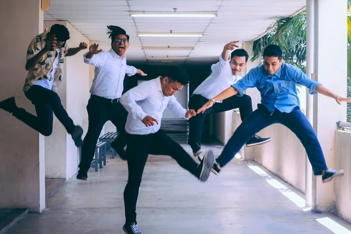 A group of 5 employees jumping in excitement 