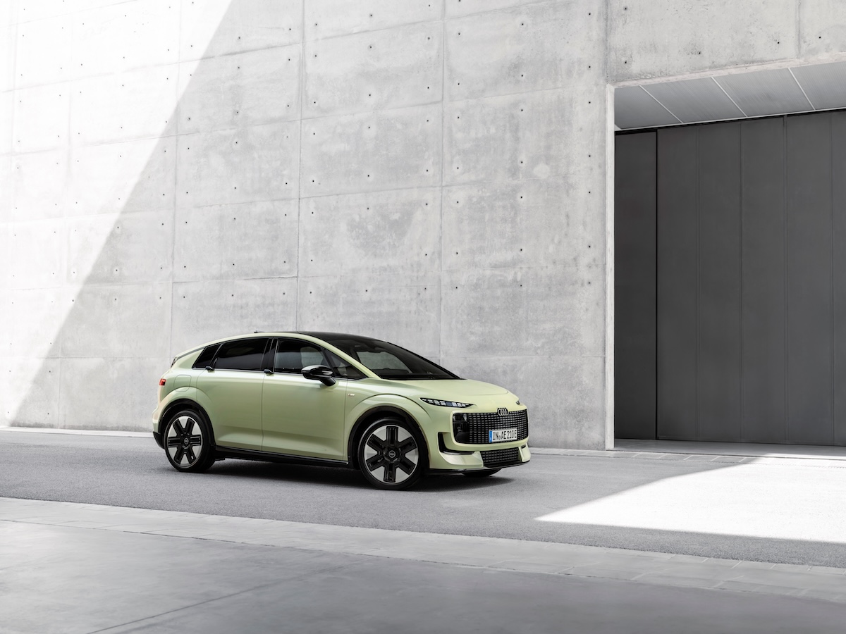 Audi A2 e-tron in pale green, front three-quarter view in a concrete studio