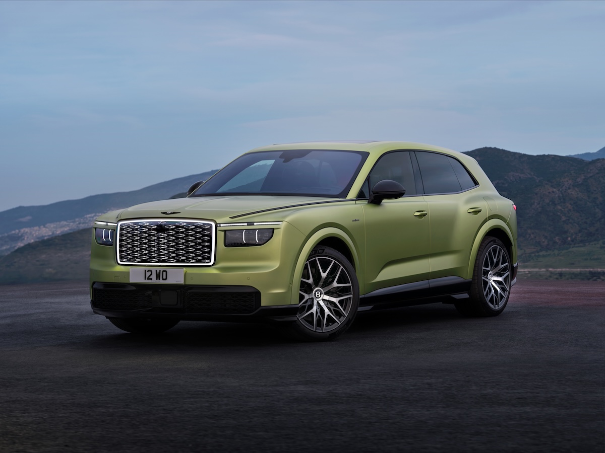 Green Bentley Torcal electric SUV parked on a mountain road