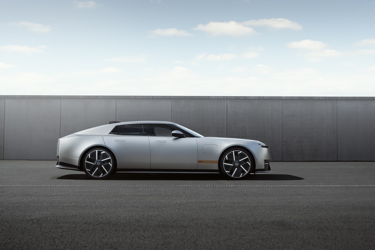 A side view of the Jaguar Type 01 in silver on a stark grey background.