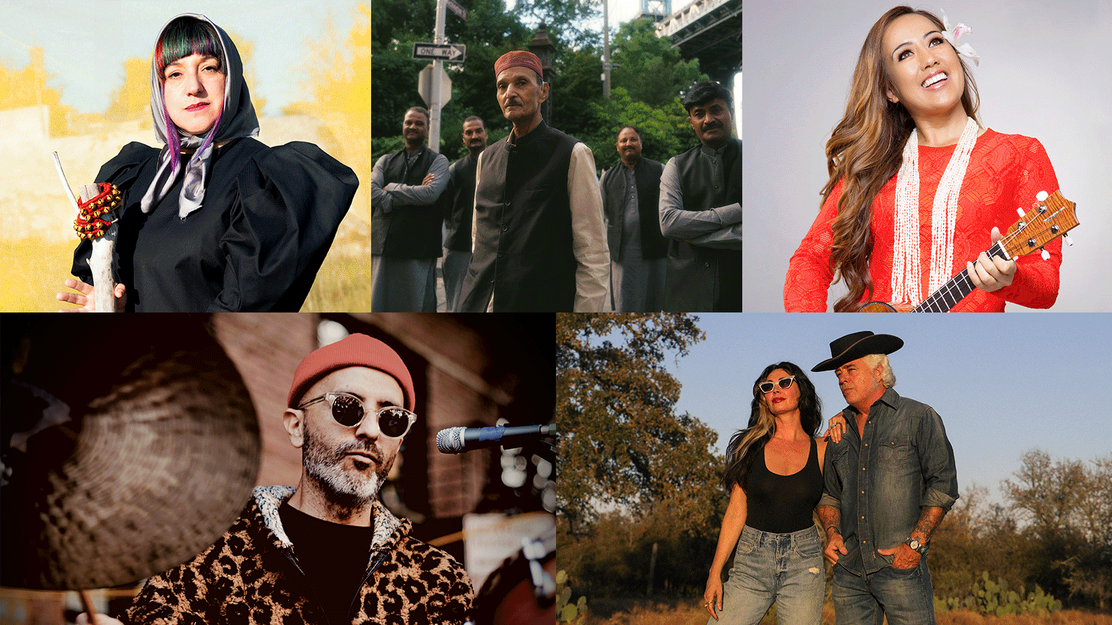 A large, engaged crowd in a three-level hall illuminated by blue lights, watches five musicians perform on stage.