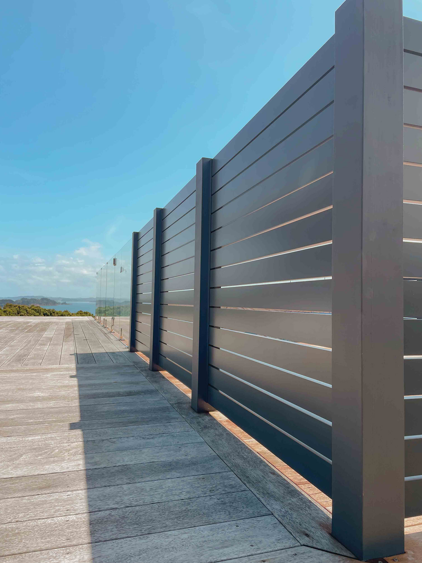 Dark slat privacy screen on a deck