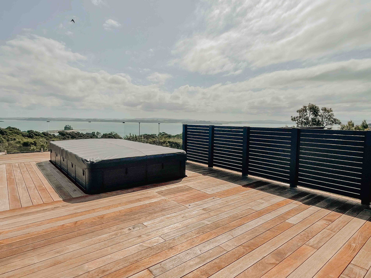 Dark slat privacy screen on a coastal deck