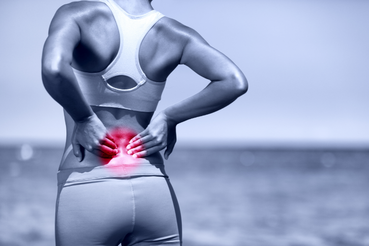 Lower Back Pain Highlighted in Female Athlete Outdoors