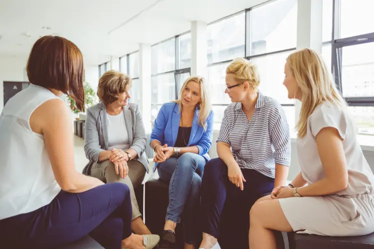 Group therapy discussion highlighting benefits in recovery journey