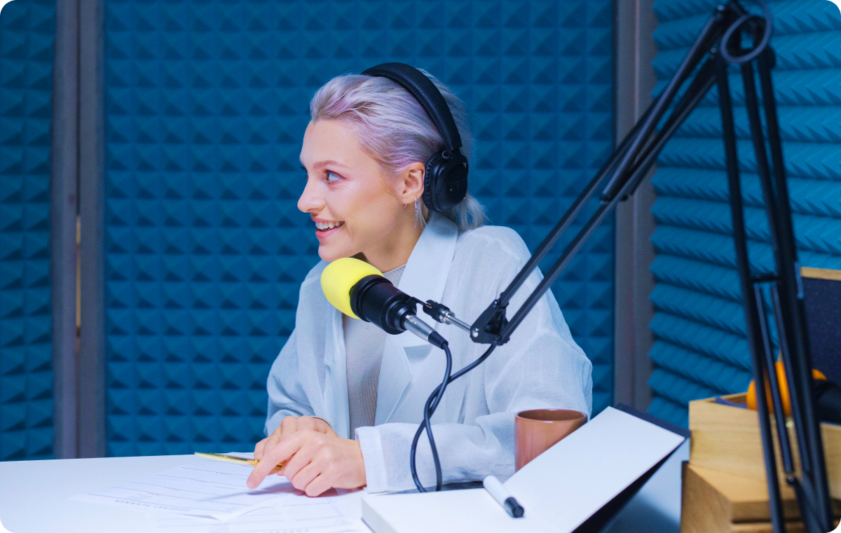 Person happily recording something on a microphone