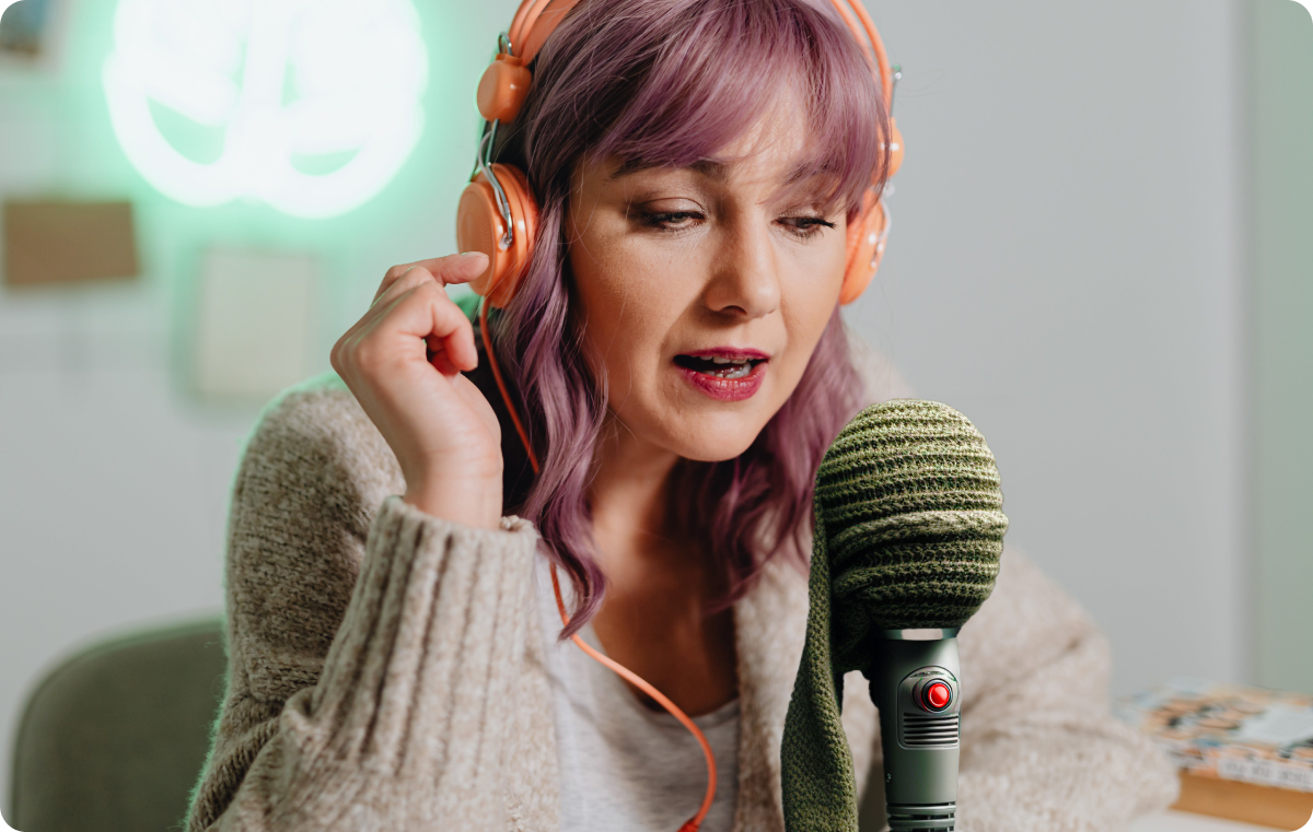 A person using a sock as a pop filter over their microphone