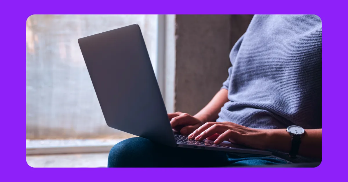 A content creator sitting in front of a laptop.