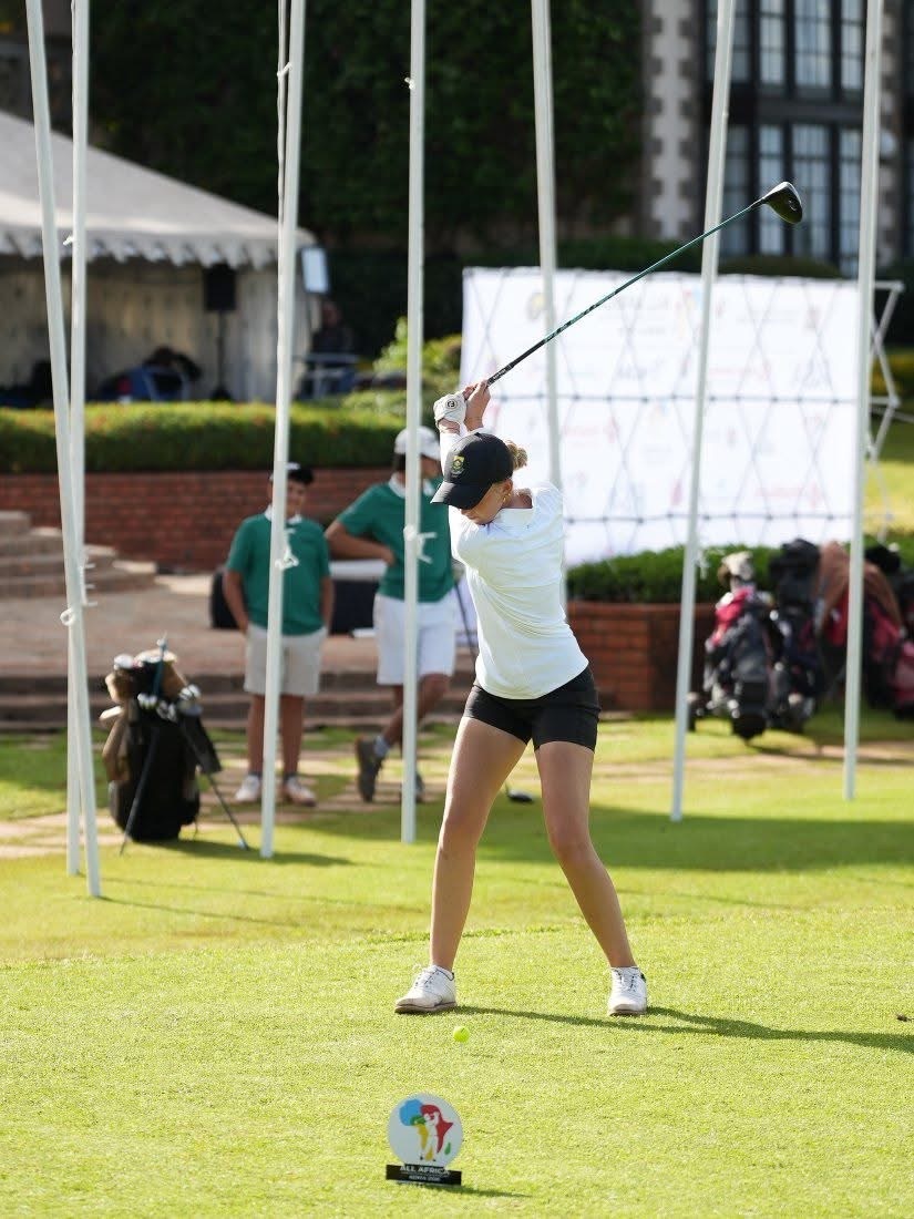 Casey, CambriLearn student and champion junior golfer, mid-swing on the course