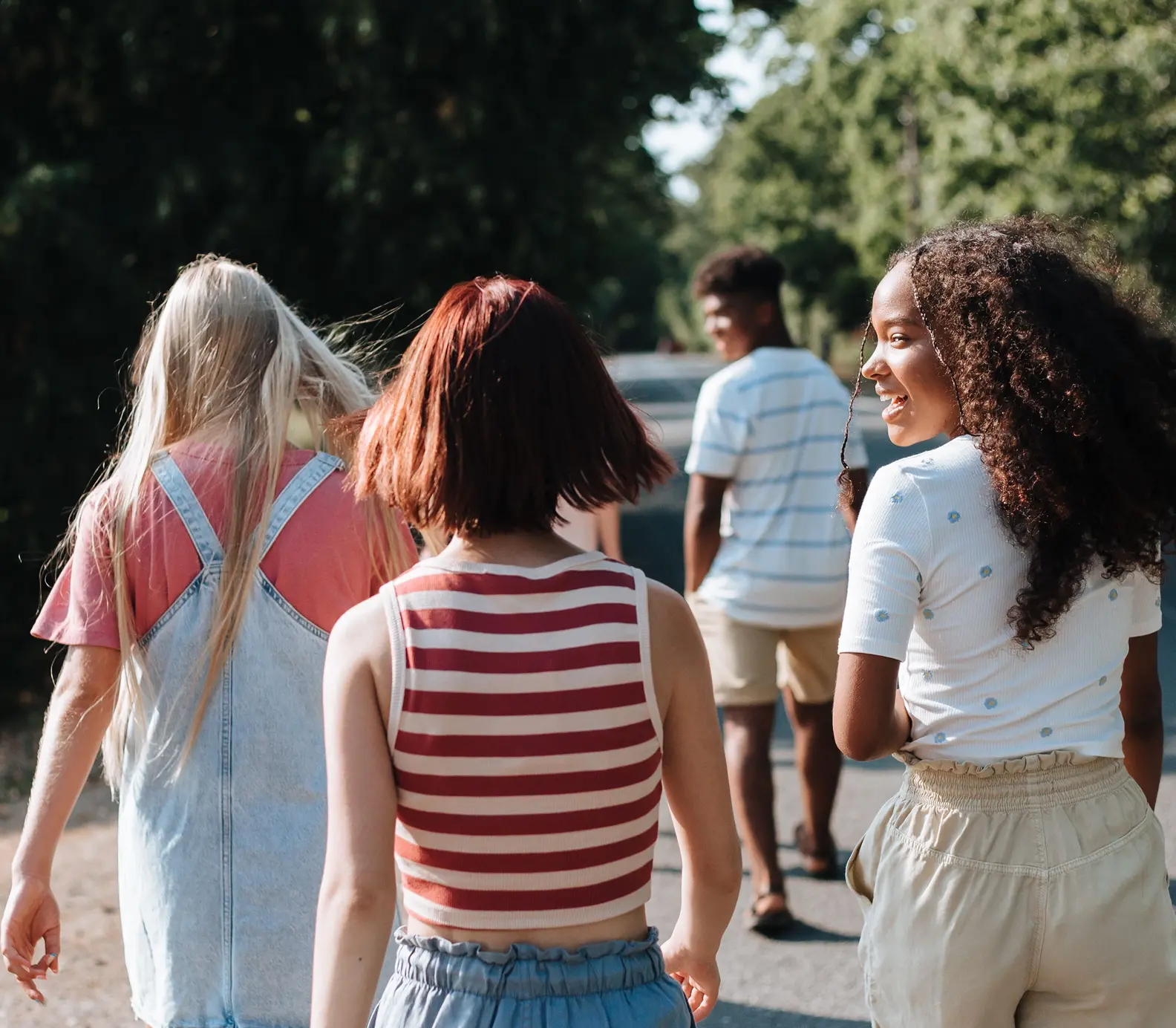 A group of teenagers walking together outdoors.