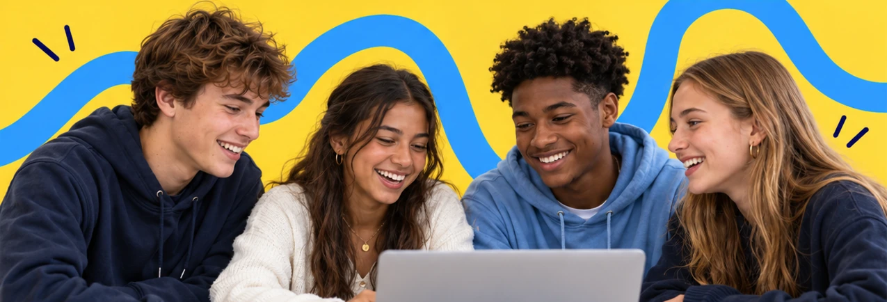 Four teenagers smiling together around a laptop