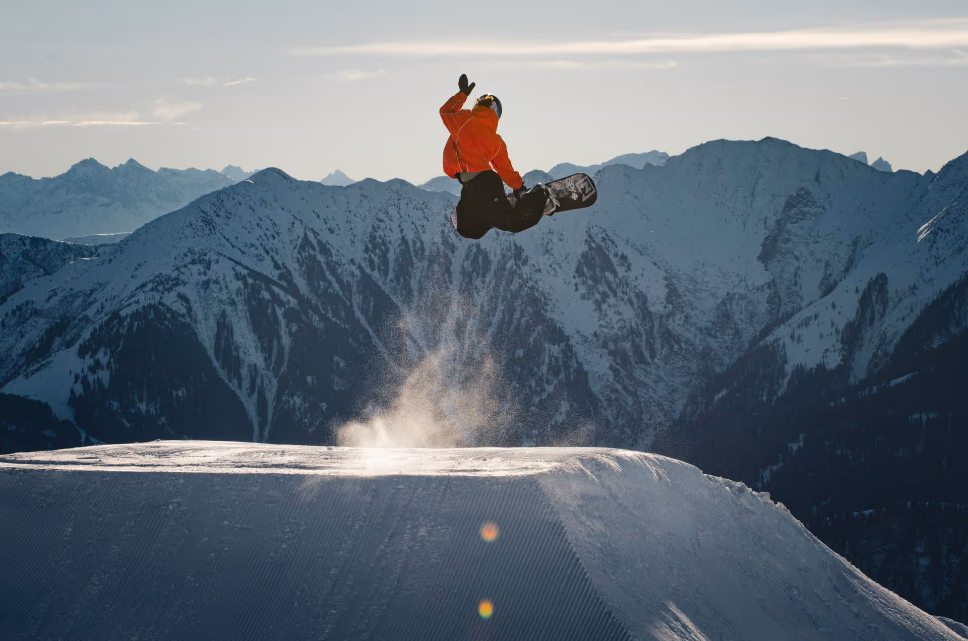 a person jumping on a snowboard