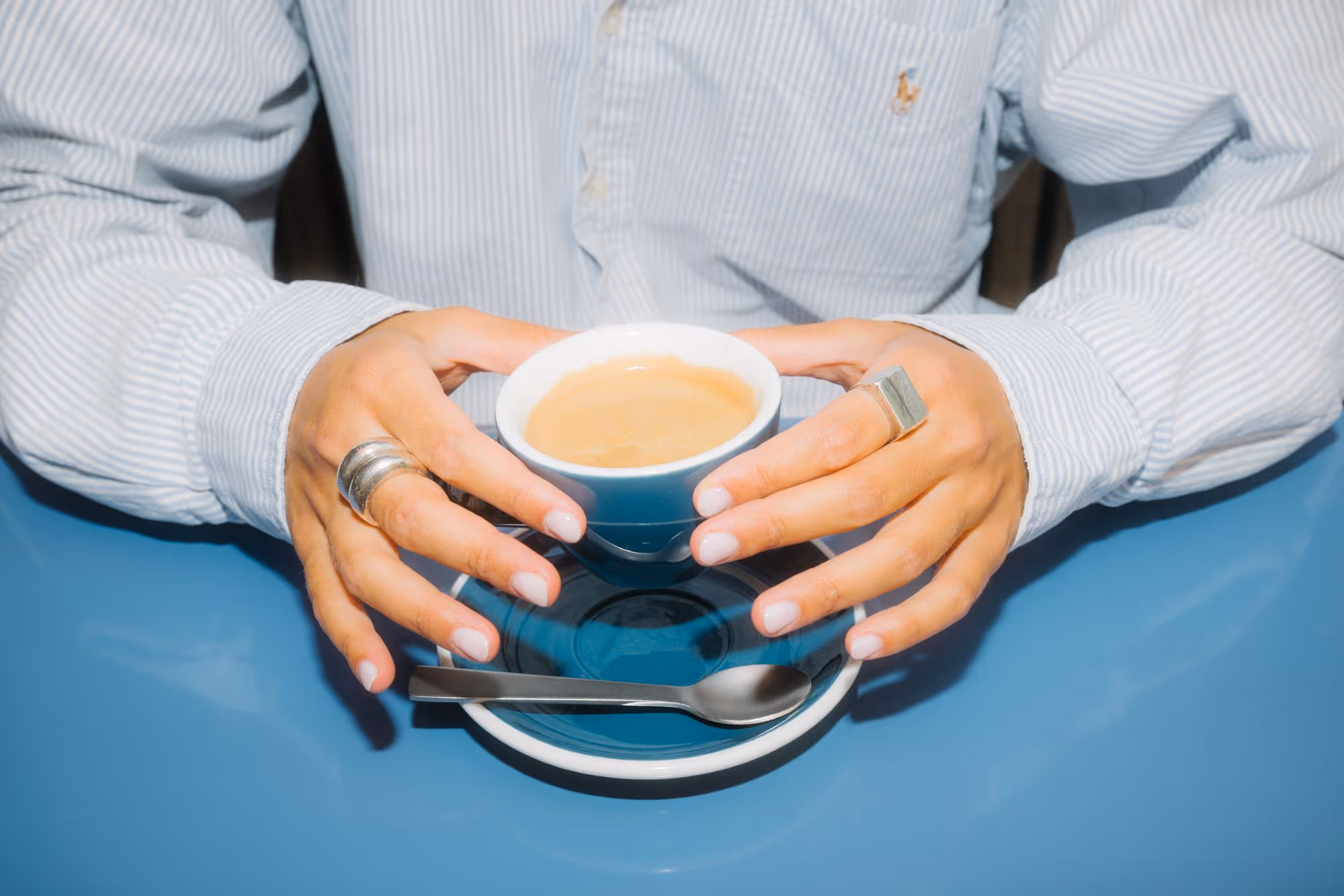 a person holding a cup of coffee