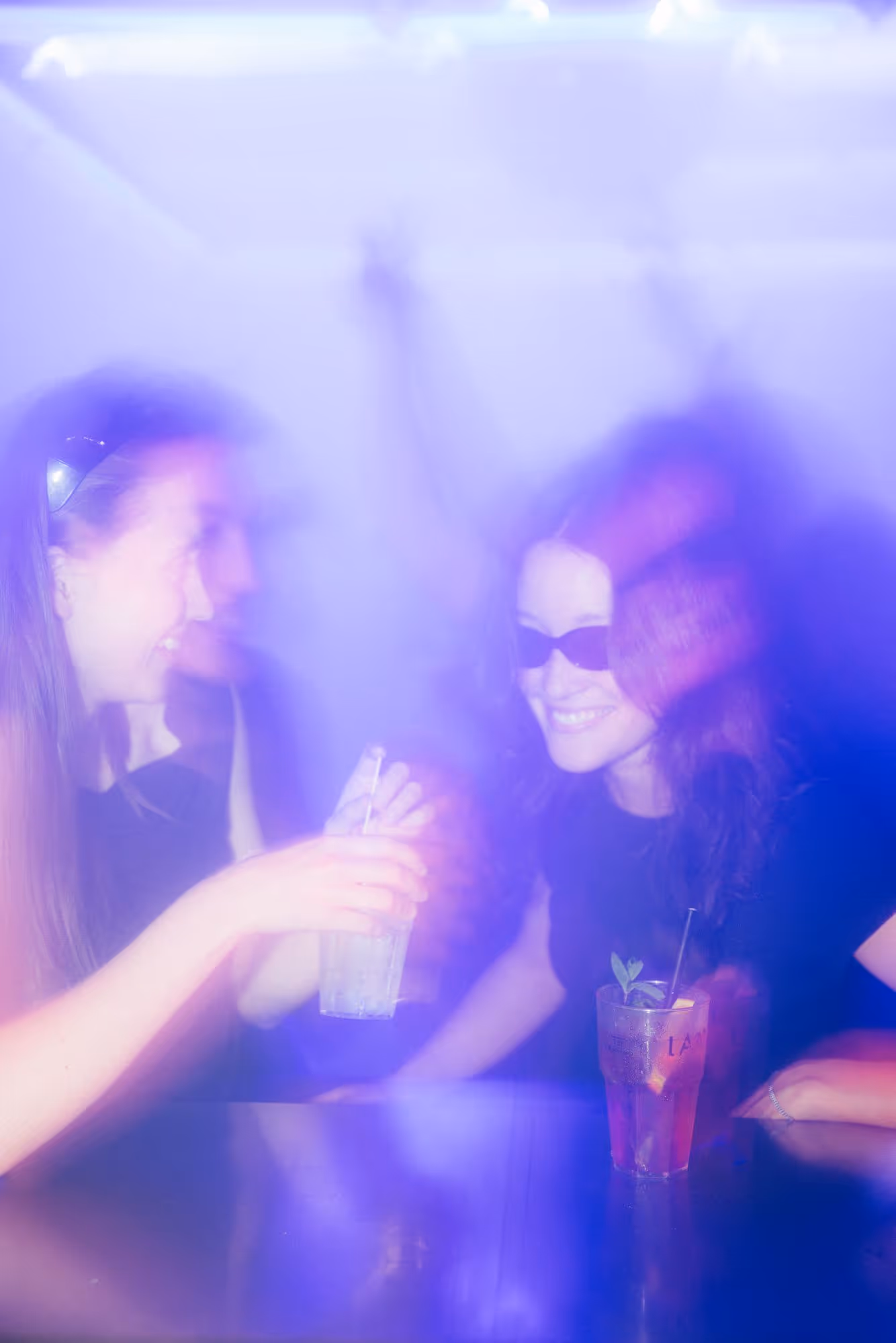 a group of women sitting at a table with drinks