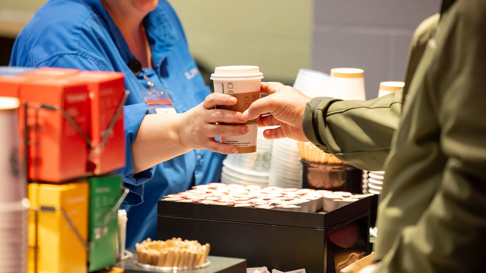 A guest being served at the Starbucks Box at WAMU Theater