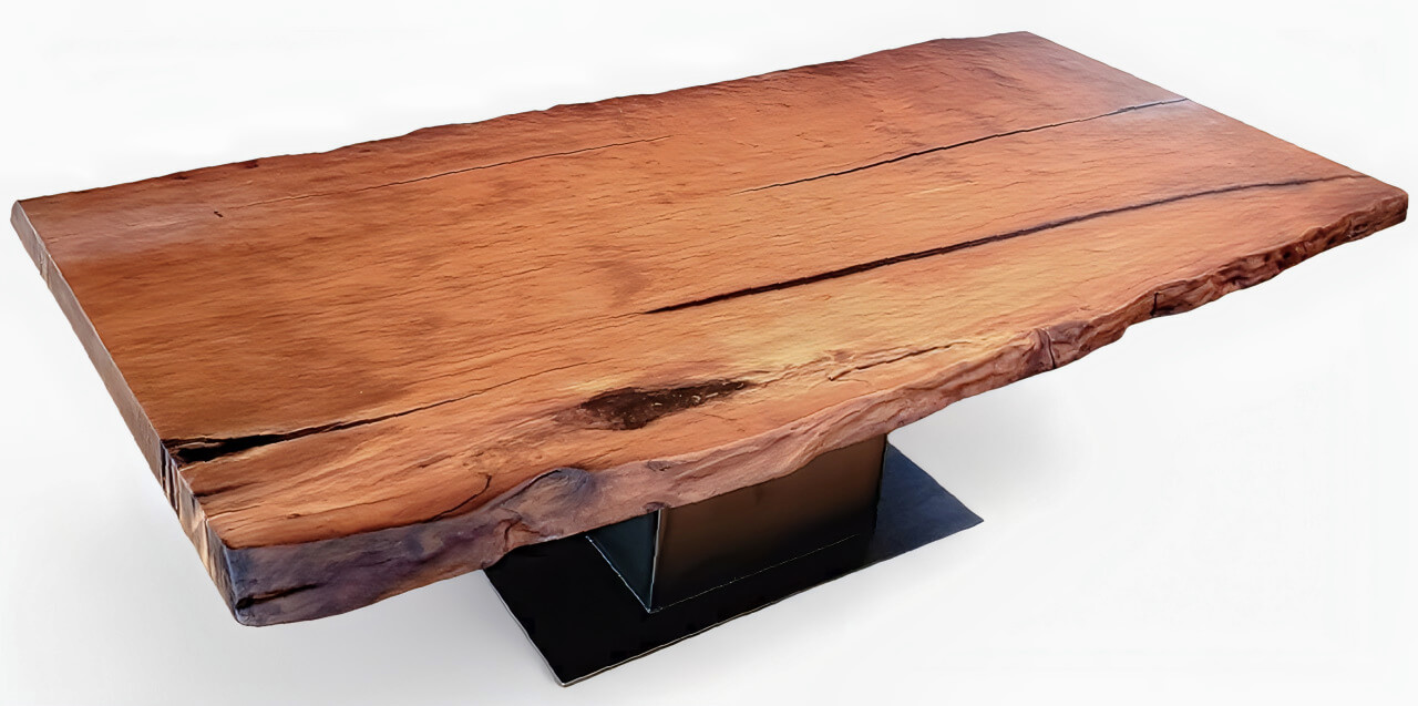 A unique tree-trunk table featuring a large tabletop crafted from a single piece of kauri wood with a natural edge, making for an extraordinary solid-wood table