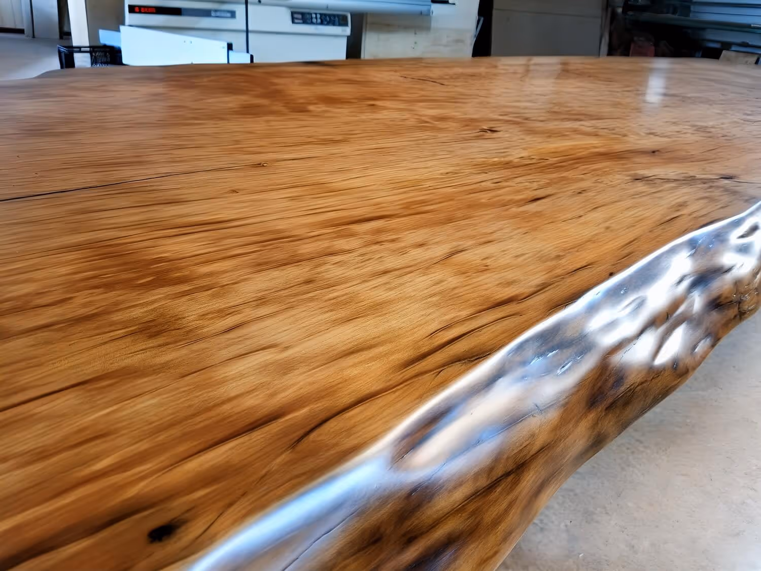 A unique tree-trunk table with a large tabletop made of subfossil Ancent Kauri wood from New Zealand, serving as an exclusive conference table