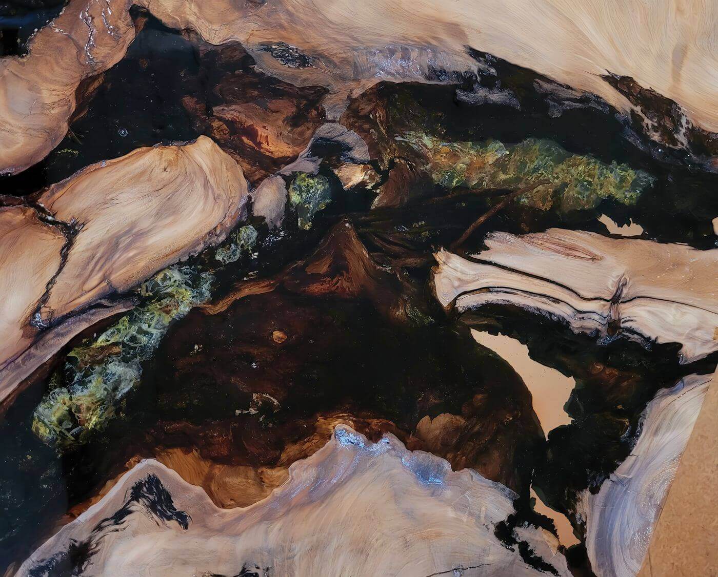 Golden amber and bark in a unique tabletop from an exclusive table crafted from millennia-old wood, perfect for extraordinary interior design projects