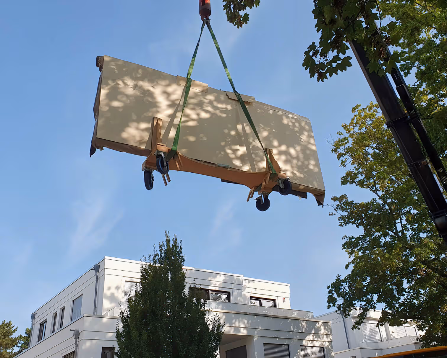 Crane delivery of a one-of-a-kind Kauri Unikat design table to an exclusive penthouse and an international project featuring distinctive interior design