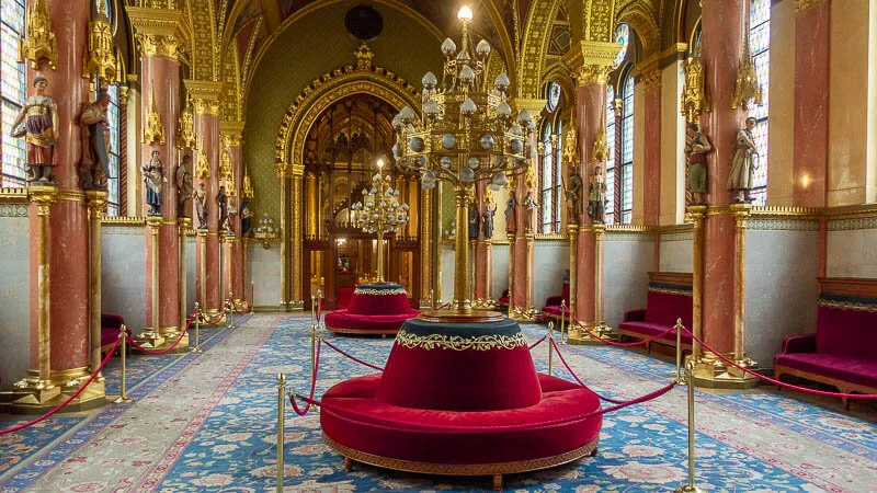 A large room with a red couch and a chandelier