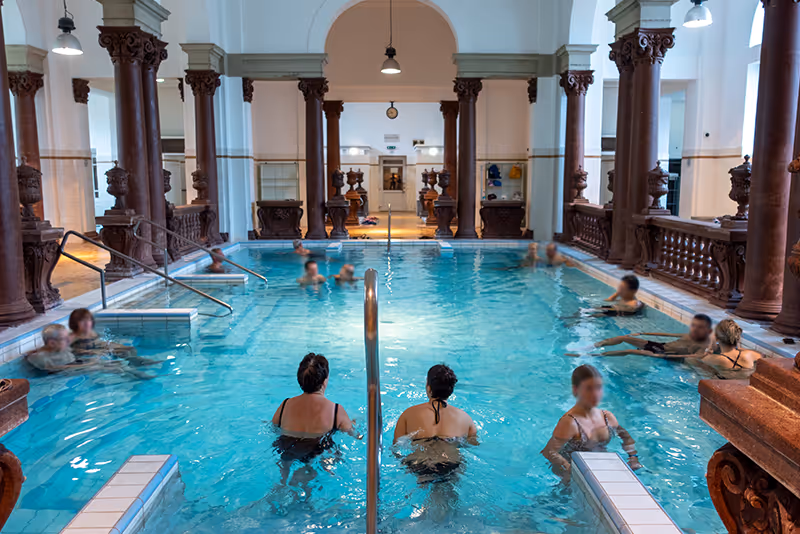 A group of people sitting in a swimming pool
