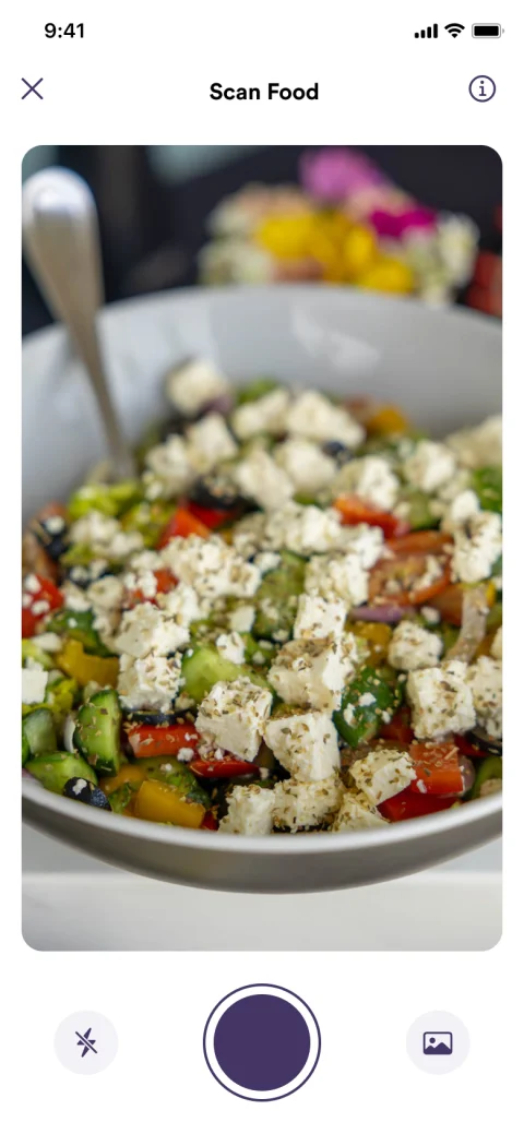 trainwell app camera pointed at a bowl of Greek salad to log a meal with a photo