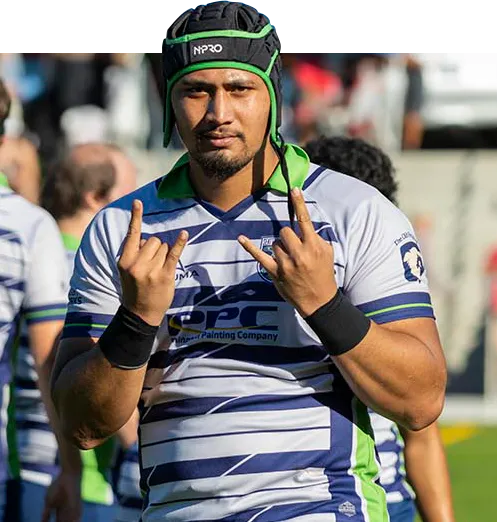 A Seattle Rugby Club player on the pitch in club kit, the Penington Painting Company mark across the chest