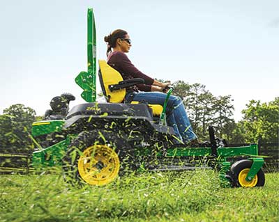John Deere z-track lawn mower cutting grass