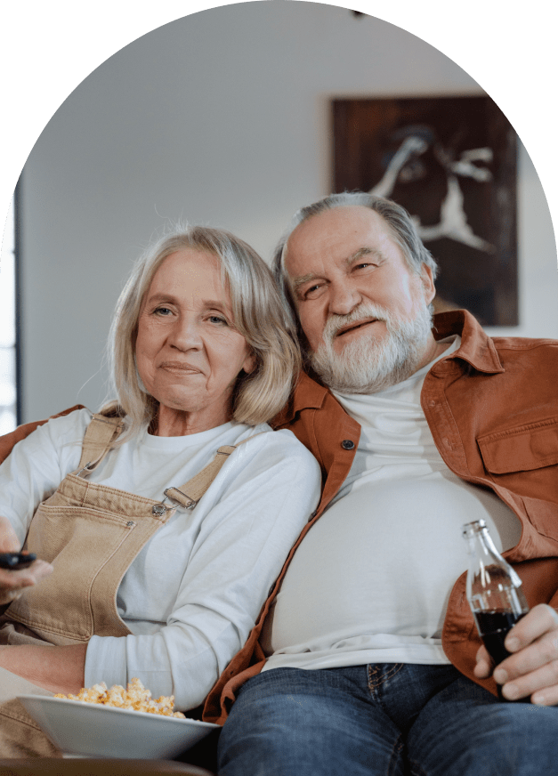 Cute older couple sitting together on couch